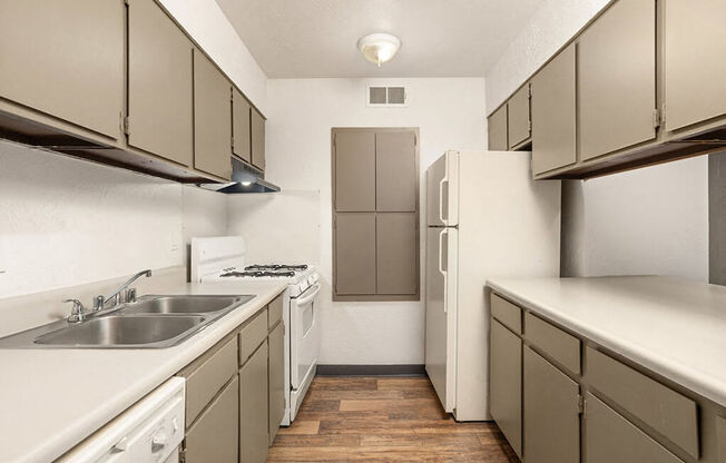 a kitchen with a sink and a refrigerator