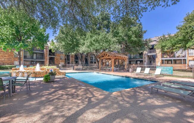 a group of palm trees next to a pool of water