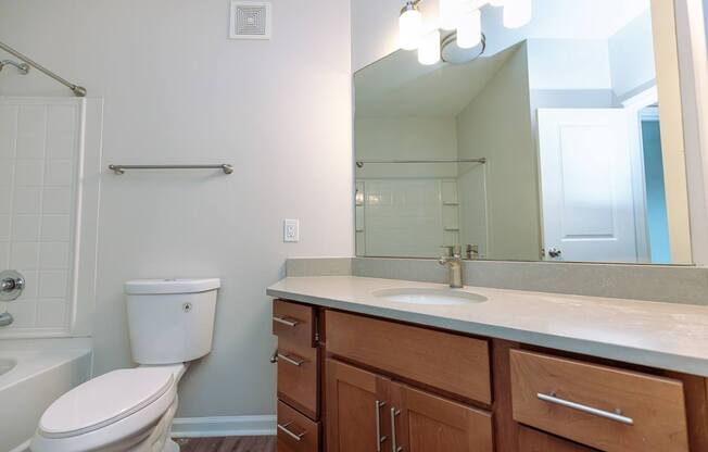 A white toilet sits next to a sink in a bathroom.
