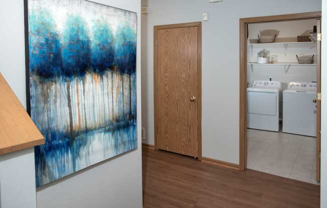 Laundry room with full size washer and dryer and shelving