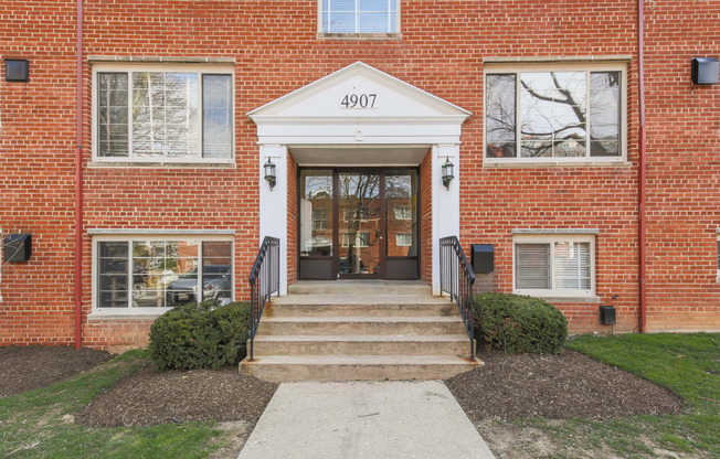 exterior entrance of brick apartments at cambridge square apartments in bethesda md