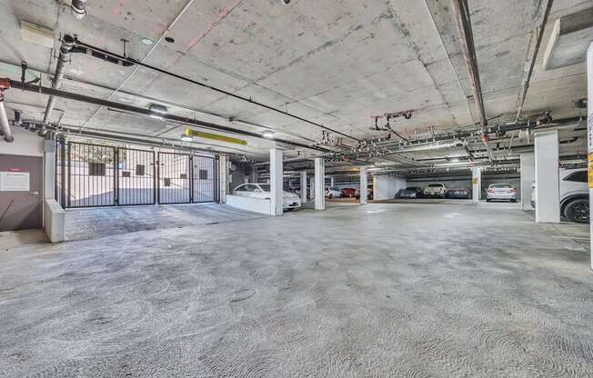 an empty parking garage with cars parked in it