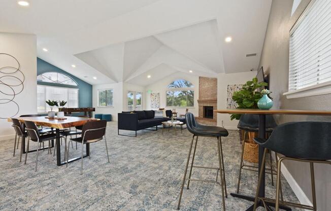 A modern living room with a dining table and chairs.