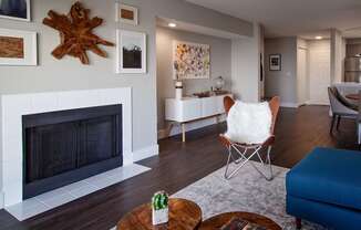 A living room with a fireplace and a chair.