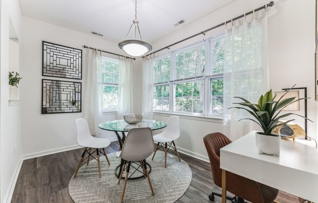 a dining room with a table and chairs and a window