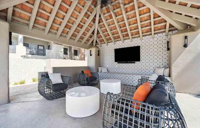 A white and black chair is in front of a white and black tiled wall.