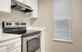 a kitchen with a stove and a window at 2000 Lake Washington Apartments, Renton, Washington