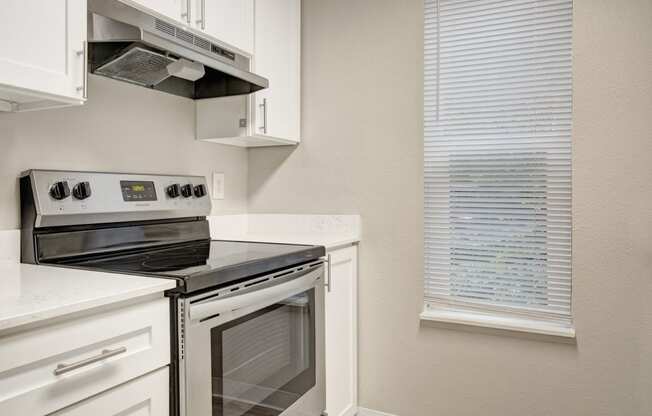 a kitchen with a stove and a window at 2000 Lake Washington Apartments, Renton, Washington