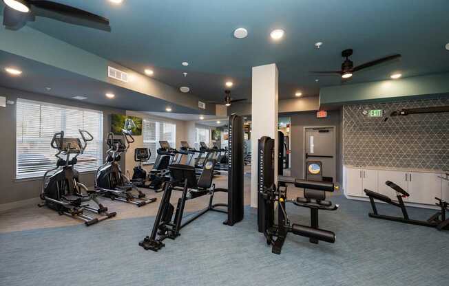 A gym with a variety of exercise equipment.