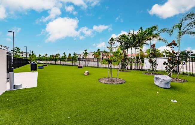 dog park with green turf and a fence at Vantage Luxury Apartments in Cape Coral, FL
