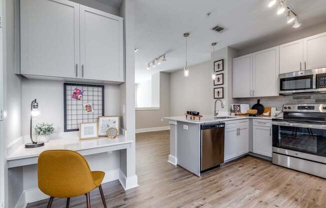 A kitchen with a yellow chair in the foreground.