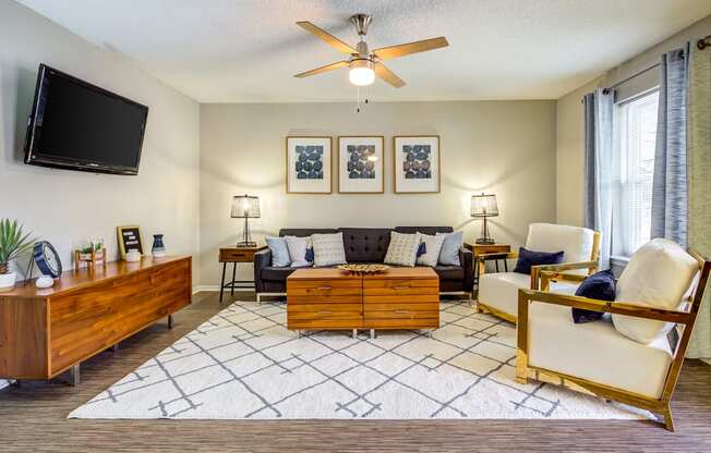 a living room with a couch and a tv at The Hub at Baton Rouge, Louisiana