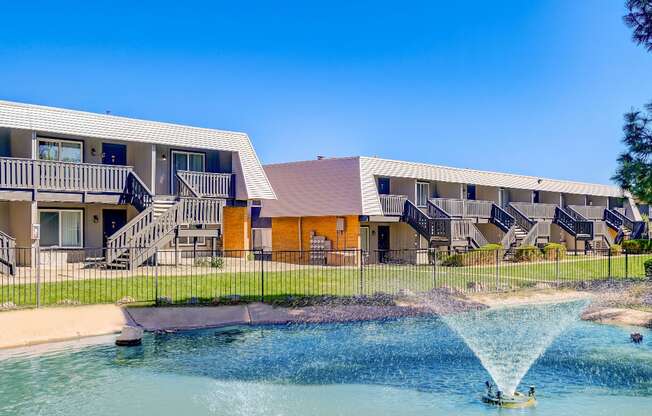 A building with a pool in front of it.