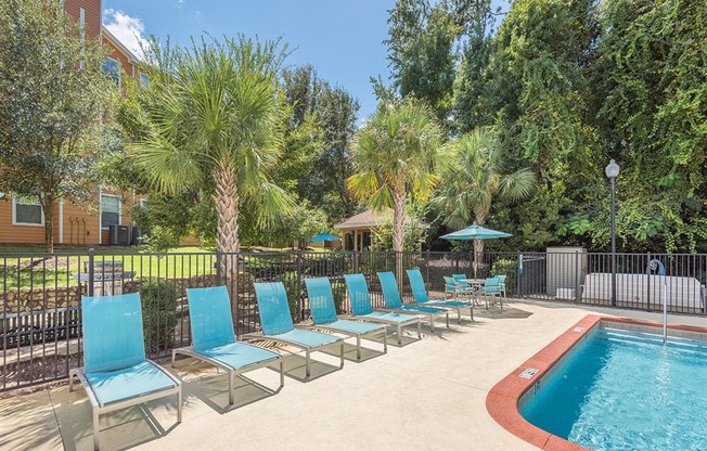 Tallahassee, FL apartment complex resort-style swimming pool with spa and lounge chairs at Evergreens at Mahan