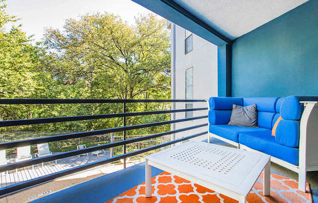 a living room with a blue couch and a coffee table