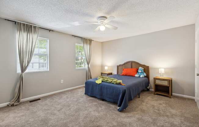 a bedroom with a bed and a ceiling fan