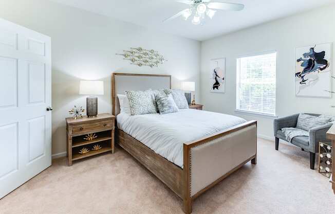 a bedroom with a large bed and a ceiling fan