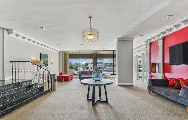 A modern living room with a black railing and a grey sofa.
