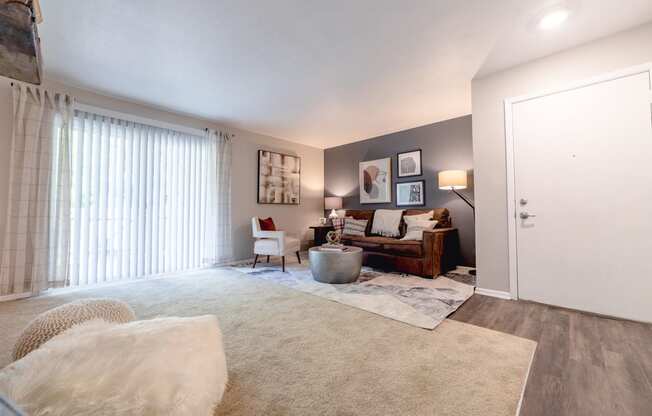 Living Room with Patio Access at Woodbridge Apartments Bloomington