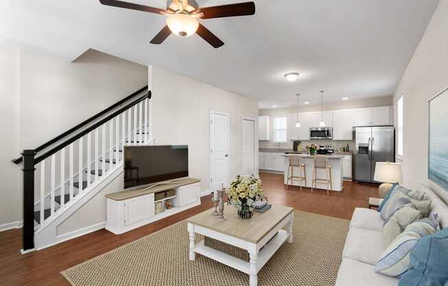 A living room with a white couch and a coffee table.
