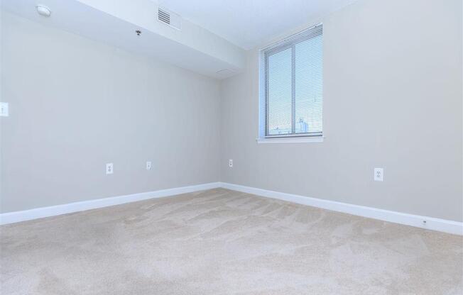 an empty bedroom with a window