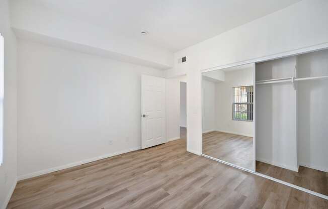 a living room with white walls and a sliding glass door