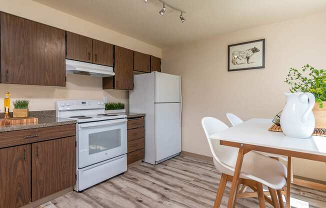 Model Kitchen with wood cabinetry and white appliances