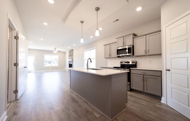 Elegant Home with Stone Fireplace, Kitchen Island and Designer Primary Suite