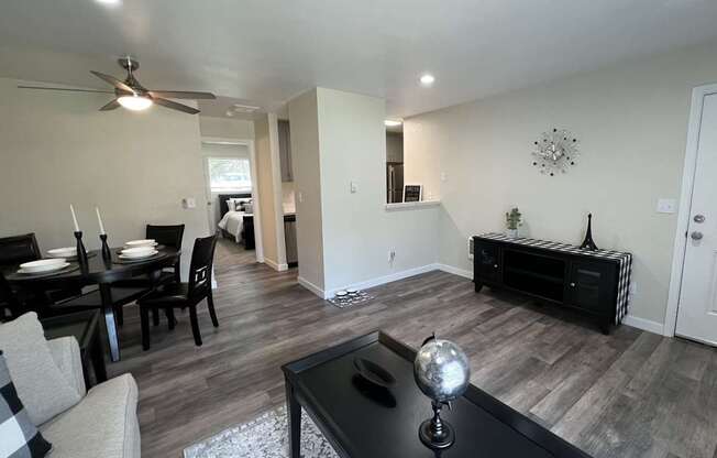A black coffee table with a globe on it sits in the middle of a living room.