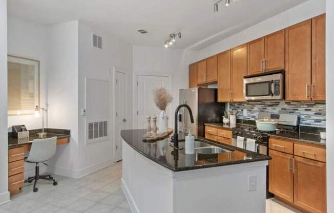 A kitchen with a black countertop and wooden cabinets.