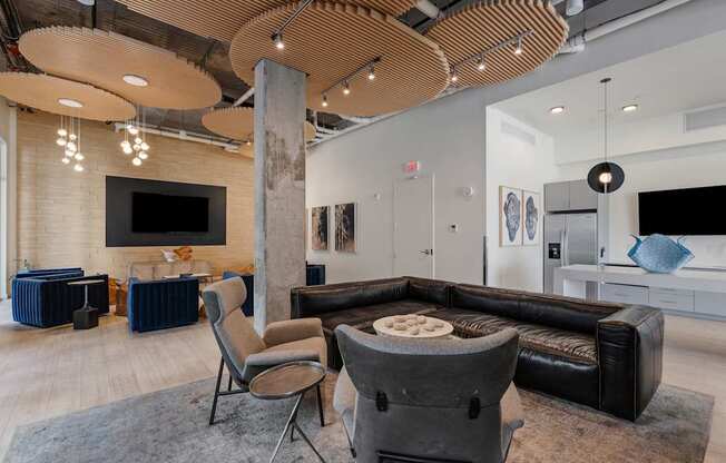 a living room with couches and chairs and a tv
