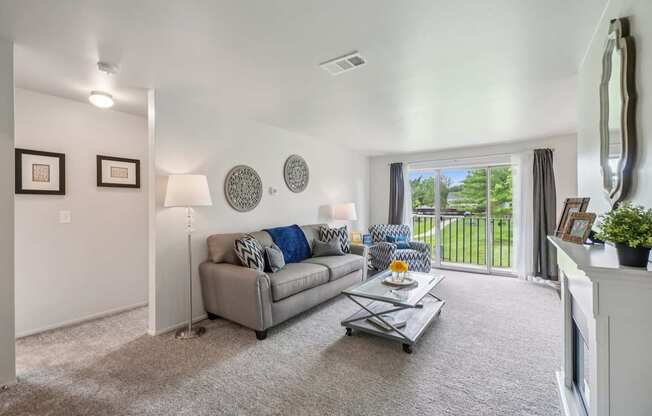 Elevated living room and private patio or balcony at Drawbridge Apartments in Harrison Township, MI.