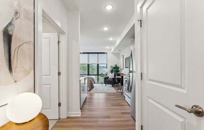 A hallway with white doors and a wooden floor.