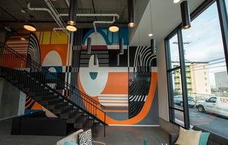 a mural in the lobby of a building with a staircase at Analog Tacoma, Tacoma, 98402