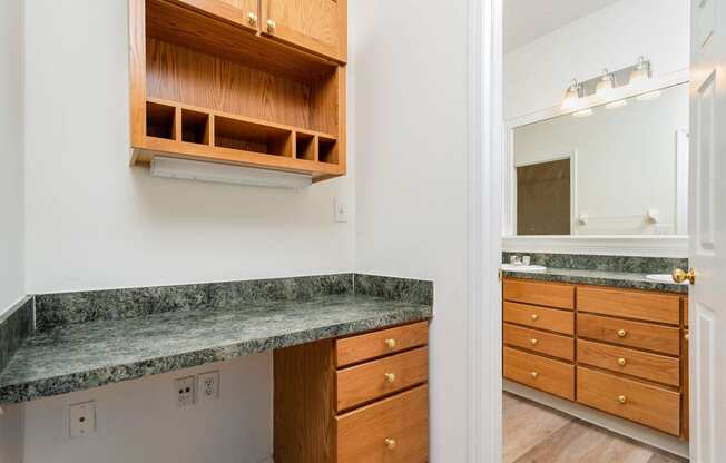 a kitchen with granite counter tops and wooden cabinets