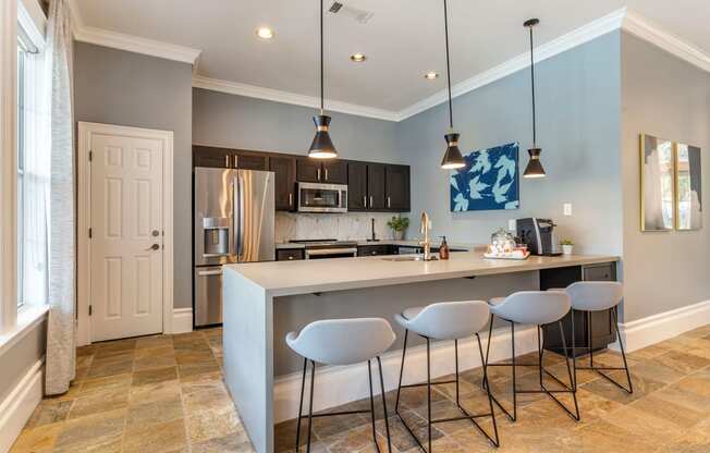 a kitchen with a bar and stools at Reserve by the Lake, Houston