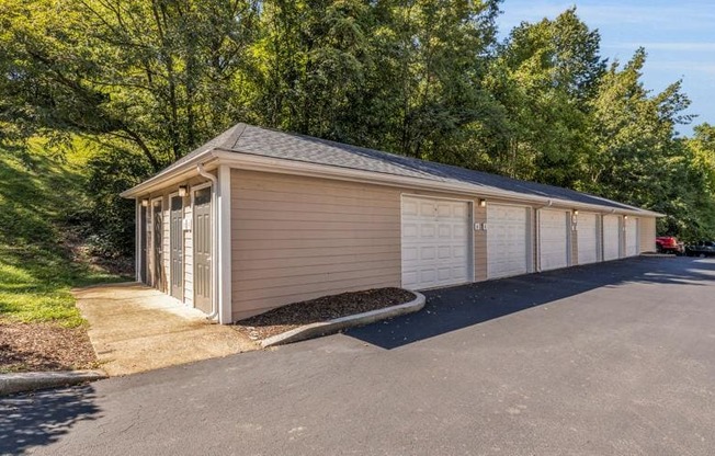 a white and tan garage with a driveway and trees at Marina Point, Chattanooga