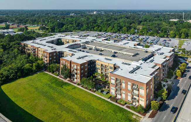 A large, multi-story building complex with a parking lot in front.