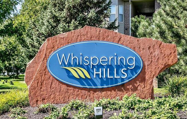 Property signage at Whispering Hills Apartments in Omaha, NE