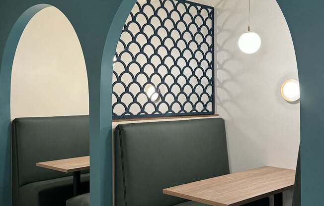 two tables and two chairs in a restaurant with an arched doorway