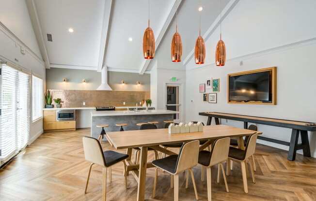 a dining room with a wooden table and chairs