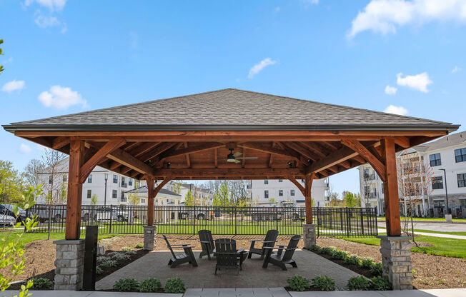 a pavilion with a table and chairs under it at Madison Prickett Preserve, Yardley
