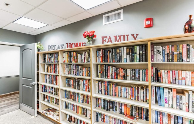 a library with a row of bookshelves and a door