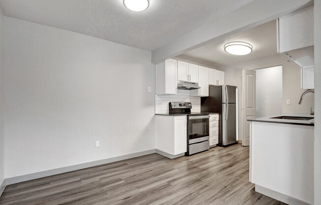 a kitchen with a stove top oven next to a refrigerator