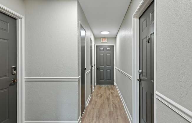 a hallway with gray walls and white trim