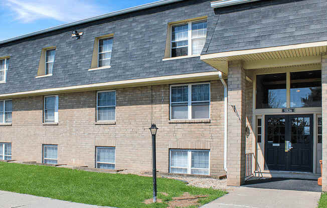 A brick building with a black door and windows.