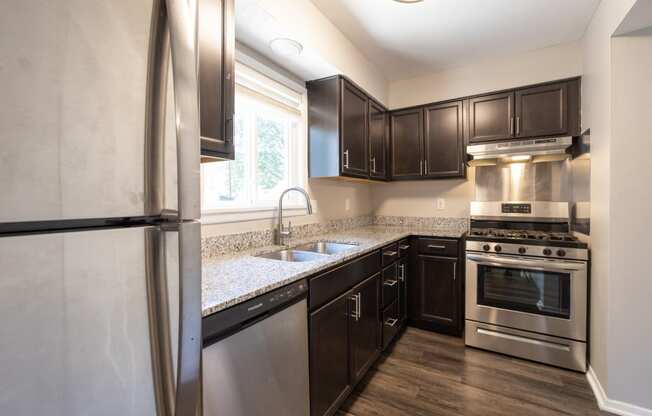 Kitchen with Stainless Steel Appliances in the Three Bedroom Townhome at Woodbridge Apartments Bloomington