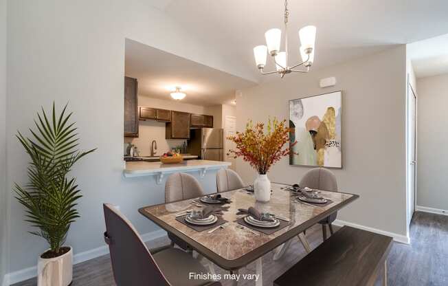 a dining room with a table and chairs and a kitchen