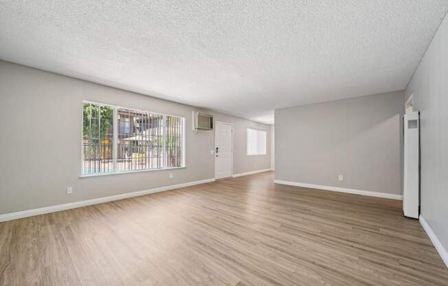A living room with wooden floors and windows