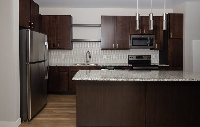 a kitchen with dark wood cabinets and a white counter top
